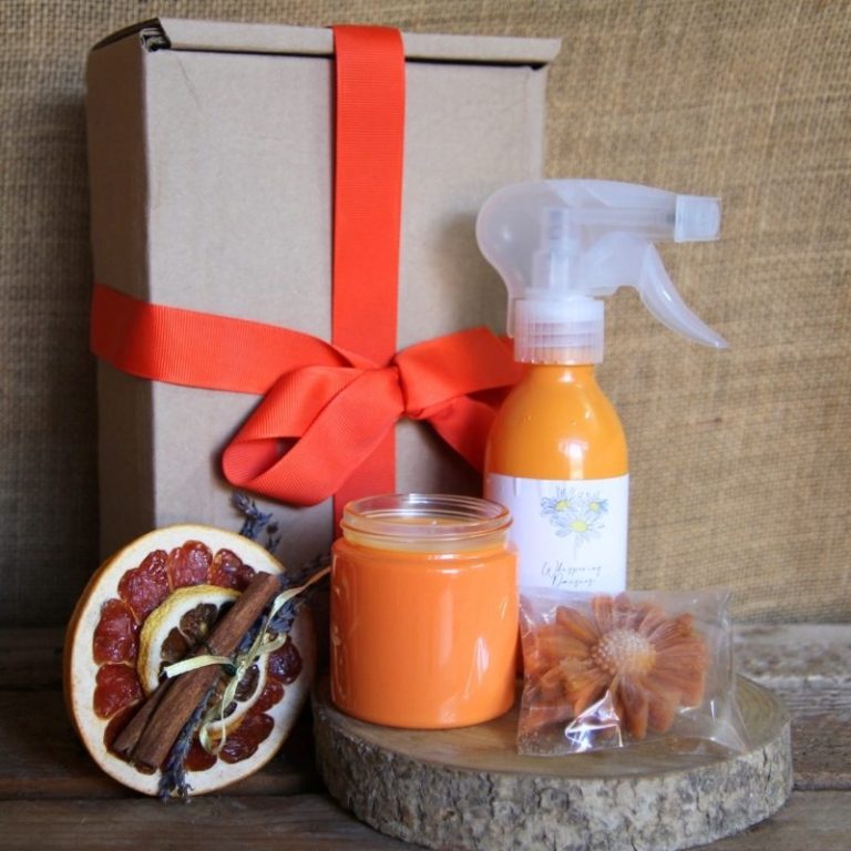 Gift box containing orange-scented products, dried orange slices, and cinnamon sticks.